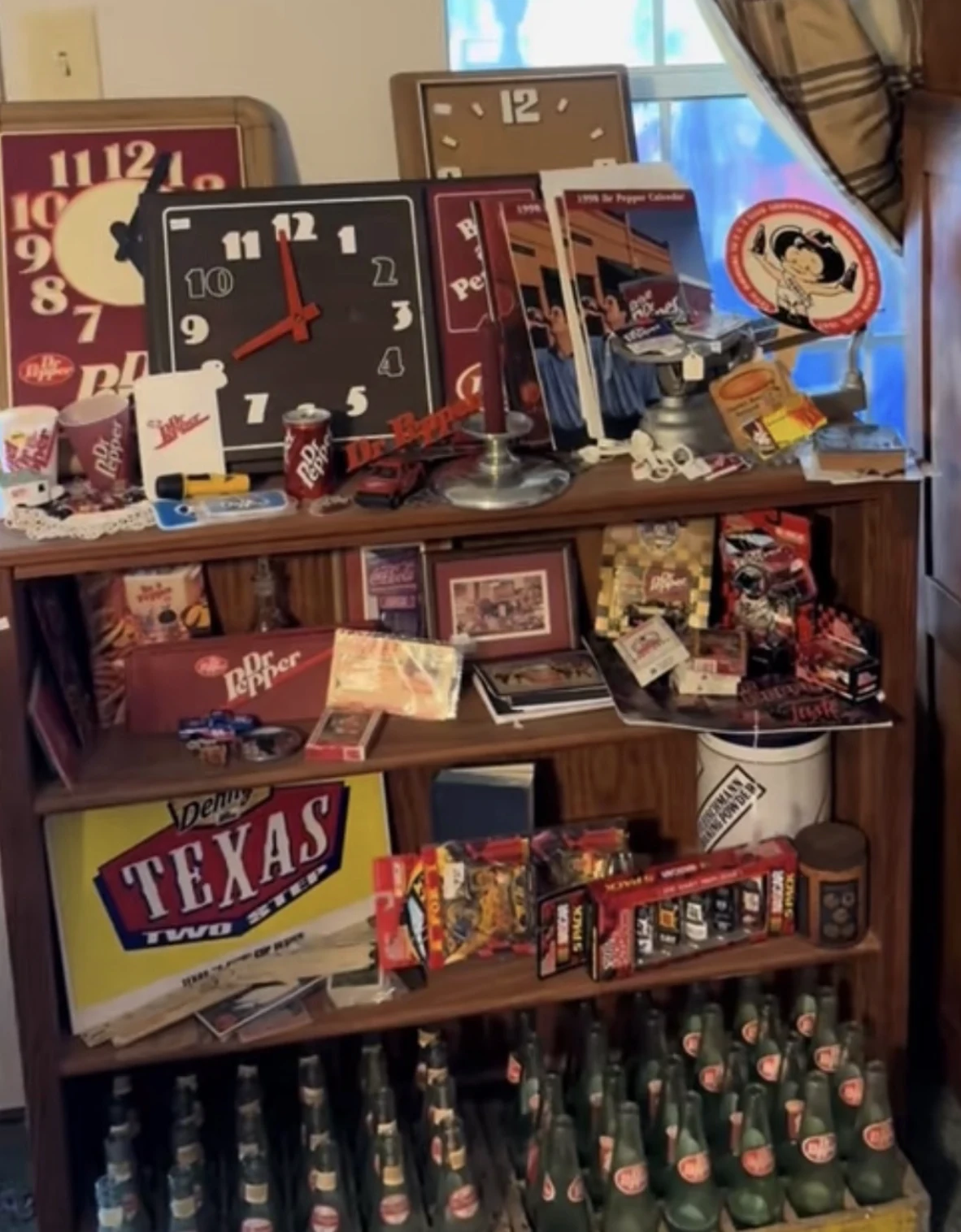 Vintage Dr Pepper signs, clocks, bottles, and memorabilia arranged on a wooden display