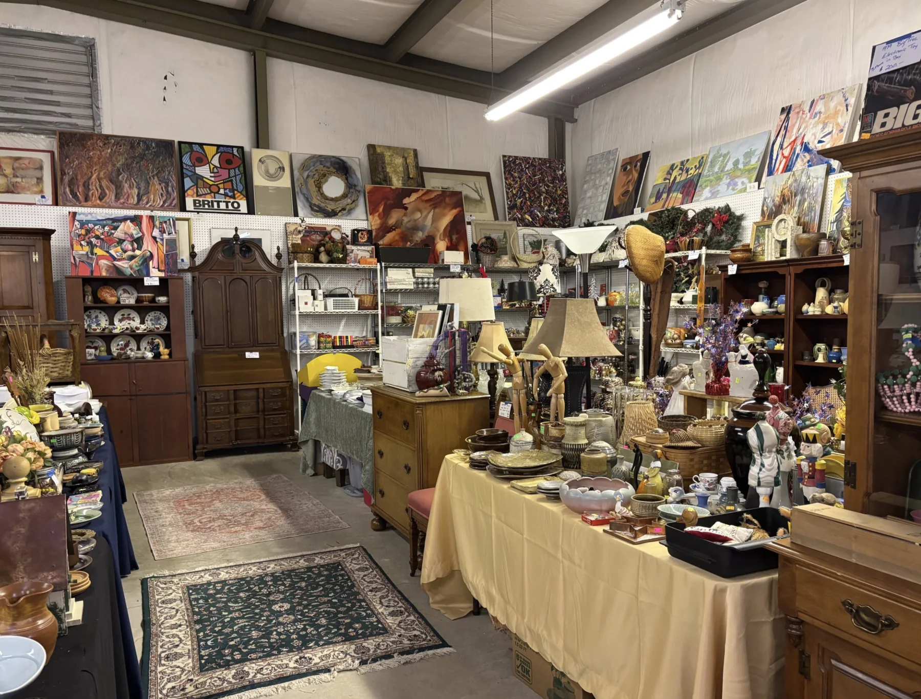Furniture and home goods arranged inside J and M’s off-site warehouse sale space